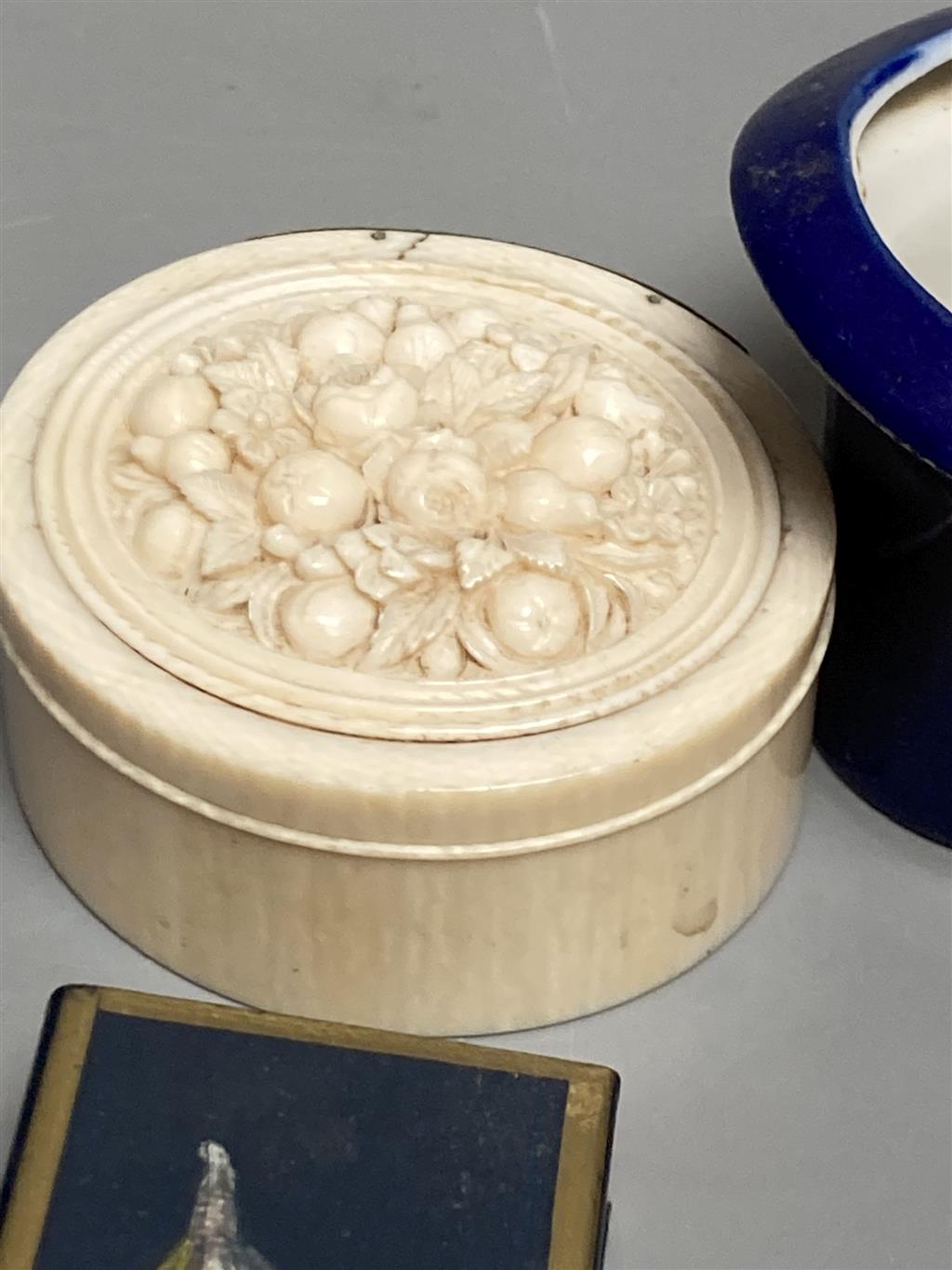 A group of small boxes and curios including a 19th century Dieppe carved ivory trinket box, 6cm.